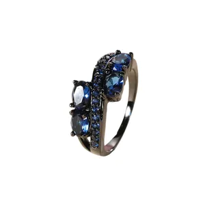 Irregular black plated ring set with navy blue cubic zirconia in a wave twist design