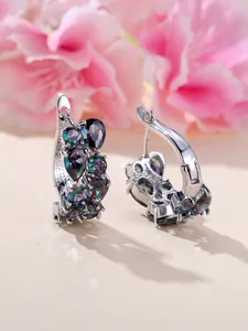 Macro shot of silver hoops with rainbow mystic topaz and pear-cut gemstone clusters