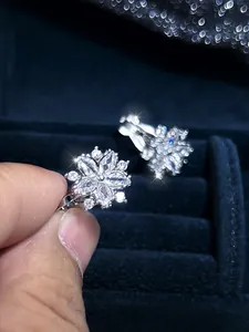 Macro view of crystal flower clip-on earrings with marquis cut petals and silver finish