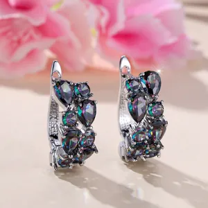 Minimalist silver hoop earrings with teardrop multi-colored zircon on floral background