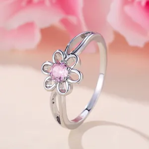 Exquisite silver flower ring with a central pink zircon in a delicate hollow design