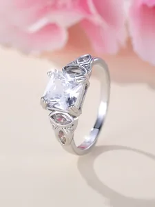Macro detail of silver square princess cut ring with marquise and round side stones