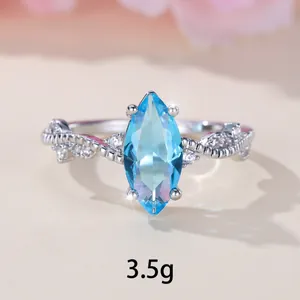 Minimalist silver marquise cut light blue gem ring with woven band design weighing 3.5g