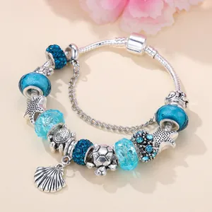 Silver ocean charm bracelet with starfish and sea turtle pendants and blue beads