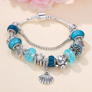 Elegant ocean-themed charm bracelet with blue beads, sea turtle, starfish and shell charms