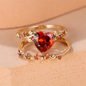 Elegant gold heart ruby ring set with zircon accents and engraved leaf patterns