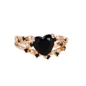 Elegant heart-shaped black zircon ring with golden twisted band and side accent stones