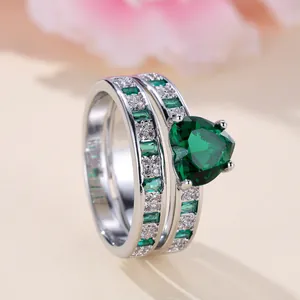 Elegant silver-tone heart-shaped emerald green zircon ring set with pave diamonds