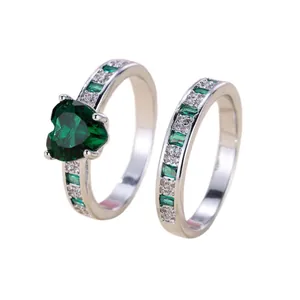 Elegant heart-shaped emerald ring set in silver finish with sparkling diamond accents