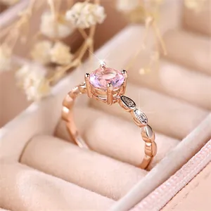 Elegant rose gold ring with large round pink gemstone in a classic four-prong setting