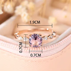 Rose gold round pink gemstone ring with diamond accents in a soft pink jewelry box