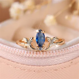 Vintage French style rose gold ring featuring a royal blue marquise gem and leaf filigree