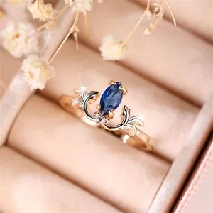 Vintage gold ring featuring marquise blue sapphire and floral filigree with diamonds