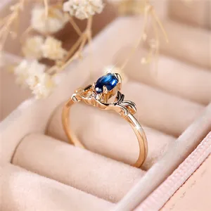 Detailed macro of a vintage gold ring with sapphire blue stone and delicate diamond accents