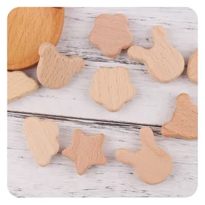 Detailed view of unfinished beech wood beads in animal shapes for DIY pacifier clips