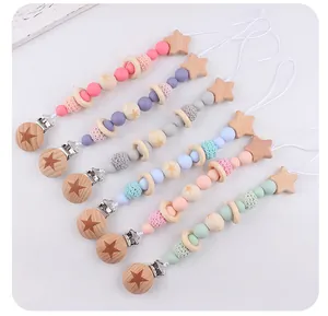 Detail view of 6-piece baby pacifier clip set with wooden stars and silicone beads