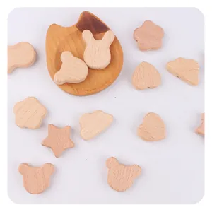Macro view of natural beech wood baby teether beads in various animal and star shapes