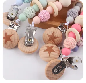 Detail of wooden star pacifier clips with macaron silicone beads and crochet textures