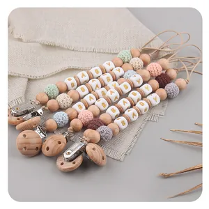Beech wood pacifier clip with colorful crochet beads and golden BABY letter cubes