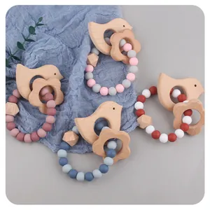 Close-up of baby teething rings made of beech wood and food-grade silicone beads