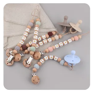 Handmade beech wood pacifier clip with silicone beads and crochet balls in Morandi colors