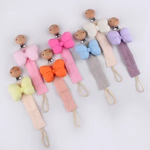 Detailset aus 7 farbigen Schnullerketten aus Baumwolle mit Buchenholzclip und Schleifen