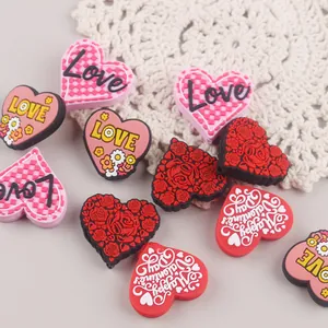 Detail of heart-shaped silicone beads with Love and floral patterns for pacifier chains