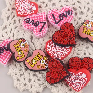 Detail of Valentine's Day themed heart-shaped PVC charms with Love and rose designs