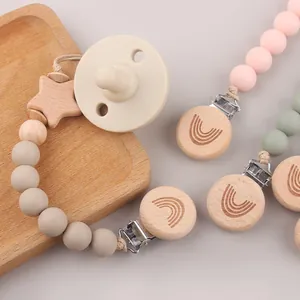 Beech wood pacifier clip set with silicone beads and star detail on wooden tray