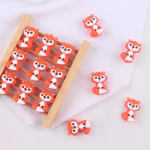Macro shot of orange silicone fox beads for baby pacifier clips and DIY teether toys