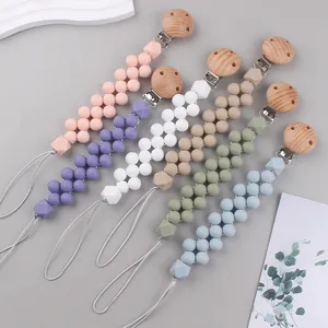 Detail view of colorful silicone beads and beech wood clips for baby pacifier chains