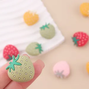 Close-up of colorful strawberry silicone beads for DIY pacifier clips and teething jewelry