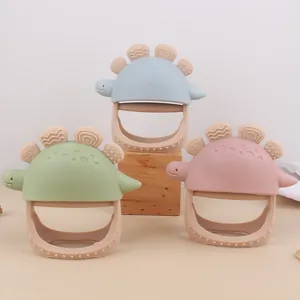 Détail de jouets de dentition dinosaure en silicone en bleu, vert et rose pastel