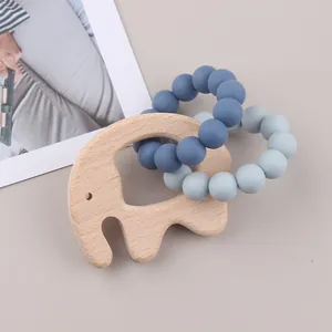 Baby beech wood elephant teether with blue silicone bead rings on a clean background