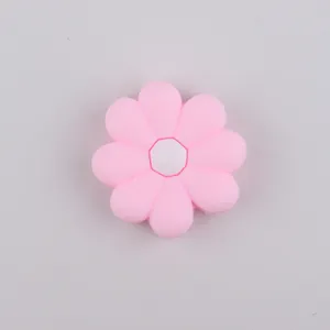 Macro detail of pink daisy silicone straw topper bead with a white octagonal center hole