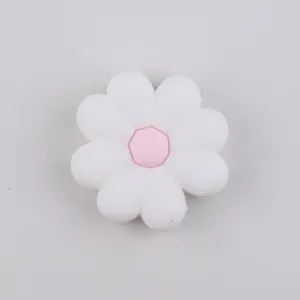 Close-up of a white and pink silicone daisy flower bead for DIY jewelry and crafts