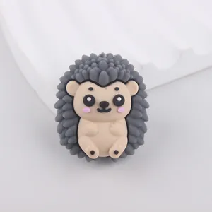 Detailed view of a cute grey and beige silicone hedgehog bead for DIY crafts and jewelry