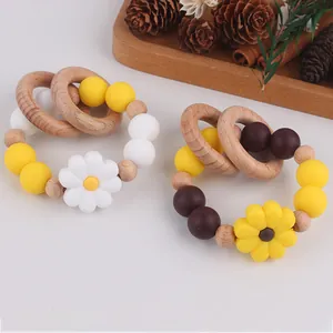 Close-up of wooden beech and silicone daisy teether ring for infant sensory play