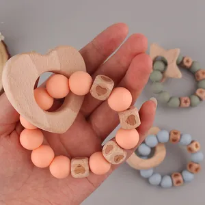Natural beech wood and silicone baby teething bracelet with heart-shaped wooden ring