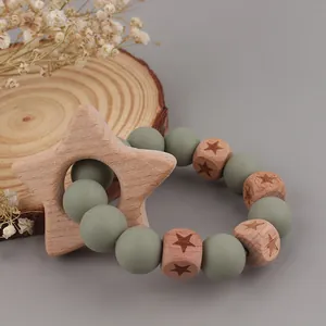 Natural beech wood and olive green silicone star teething ring for infant sensory play