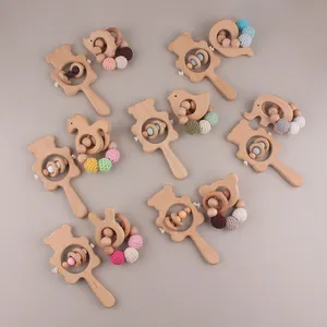 Detail of wooden bear rattle baby teether with colorful handmade crochet beads