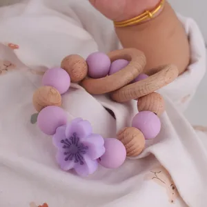 Newborn beech wood and purple silicone flower teething bracelet for baby sensory play