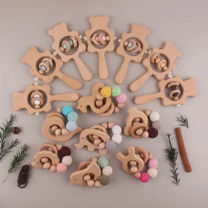 Detail of wooden bear rattles and handmade beaded rings for baby teething and motor skills