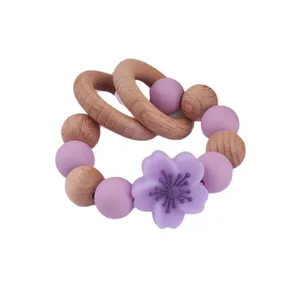 Beech wood and purple silicone flower baby teether bracelet with dual wooden rings