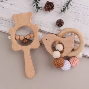 Detail of wooden bear rattle and bird teething ring with crochet beads for infants
