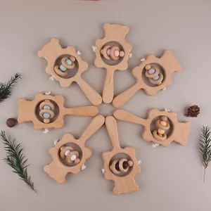 Detail of wooden bear baby rattles with colorful silicone beads and smooth beechwood rings