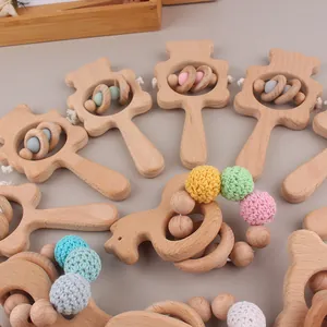 Detail view of beech wood baby rattle and colorful crochet beads teething set