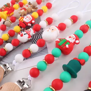 Detailed view of food-grade silicone pacifier clips with festive Christmas-themed beads