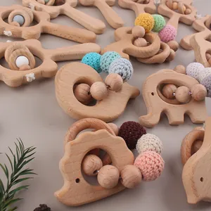 Macro detail of beech wood elephant teether with handmade crochet beads and wooden rings