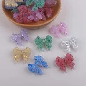 Close-up of colorful glitter resin bow beads for DIY baby pacifier clips and jewelry